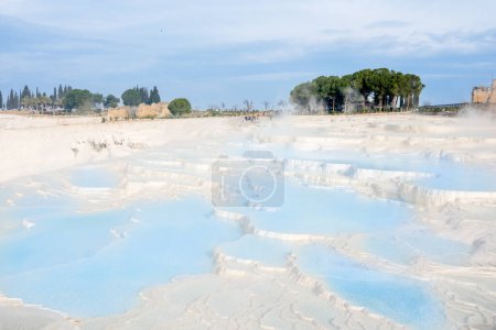 Photo for Pamukkale, Turkey, a breathtaking natural wonder that features a series of stunning terraced hot springs and travertine formations. Visitors can soak in the mineral-rich waters, hike through the picturesque landscape, and explore the ancient ruins of - Royalty Free Image