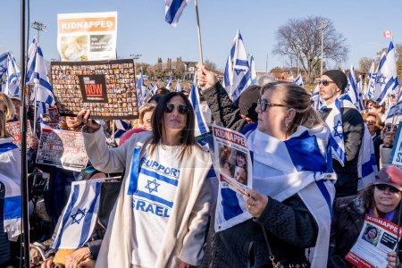 Photo for The UJA (United Jewish Appeal) Solidarity Rally For The Hostages in Toronto on November 12, 2023 transformed the park into a focal point of collective empathy, as participants, against the backdrop of solidarity banners - Royalty Free Image