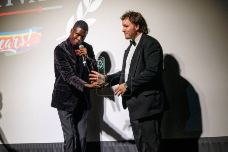 Photo for Buffer Festival 2023 at the Drake Hotel and Paradise Theatre, November, Toronto, Canada: Tope Babaloa presents Liam Death with Excellence in Cinematography award for The Delivery. - Royalty Free Image
