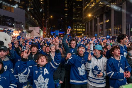 Photo for TORONTO, ONTARIO, CANADA - APRIL 20, 2024: fans gather in Maple Leaf Square outside Scotiabank Arena to watch play off game on big screen, Toronto hockey game - Royalty Free Image