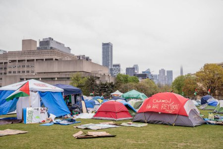 Photo for Signage and spray painted tents with pro-Palestinian messaging at University of Toronto. Students are occupying the campus with a pro-Palestinian encampment, reflecting global movements for Palestinian rights, while erecting barriers that exclude dis - Royalty Free Image