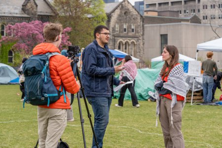 Photo for Student spokesperson talks to the media at  pro-Palestinian encampment, which students created by occupying King College Circle at University of Toronto. - Royalty Free Image