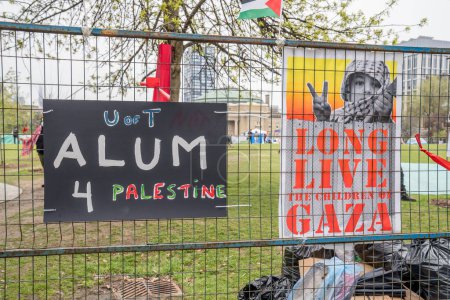 Photo for Signage with pro-Palestinian messaging at University of Toronto. Students are occupying the campus with a pro-Palestinian encampment, reflecting global movements for Palestinian rights, while erecting barriers that exclude dissenting views, intensify - Royalty Free Image