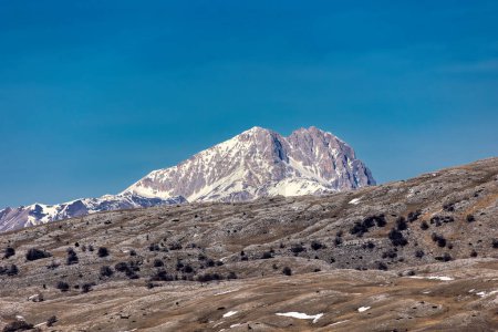 Snowy mountain panorama on blue sky background. Central Italian Apennines. Maiella mountain massif in the continental Apennines in Italy.