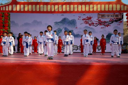 Photo for Rome, Italy - February 18, 2024: Chinese New Year celebrations in the square, public event. Children perform martial arts techniques on stage. - Royalty Free Image