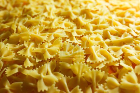 Photo for Pasta from durum wheat. Raw farfalle. Healthy food. Italian dishes. - Royalty Free Image
