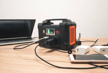 lithium Portable Power Station is charging laptop smartphone