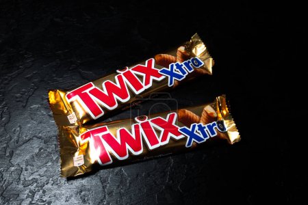 Photo for LVIV, UKRAINE - January 25, 2023 : Twix Xtra chocolate bar on black background. - Royalty Free Image