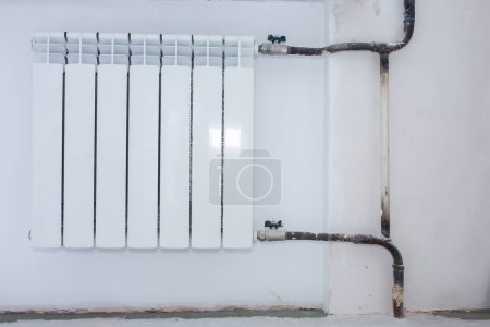 Photo for Radiator battery in the room. Maintenance repair works renovation in the flat. Heating restoration. - Royalty Free Image
