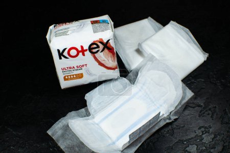 Photo for LVIV, UKRAINE - April 20, 2023 : Package of "Kotex Ultra Soft" sanitary pads on black background. - Royalty Free Image