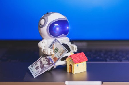 Foto de Robot con dinero en dólares y casa - Imagen libre de derechos