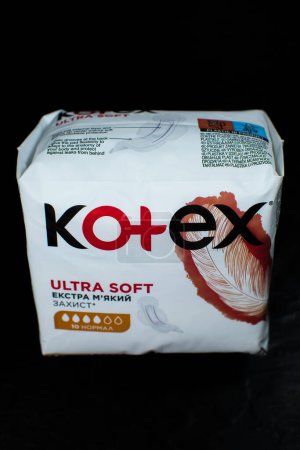 Photo for LVIV, UKRAINE - April 20, 2023 : Package of "Kotex Ultra Soft" sanitary pads on black background. - Royalty Free Image