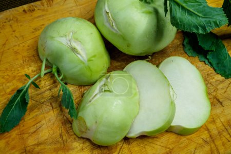 Fresh kohlrabi cutting on wooden board prepare for cooking. Brassica oleracea Gongylodes Group