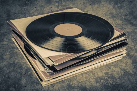 Vintage vinyl record on grunge background, retro toned.