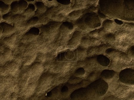Photo for Natural stone It is shaped like a honeycomb hole. Weathered ancient stone covered in holes. Close up photo of the texture of a mountain rock. Film and grian simulation on processing. - Royalty Free Image