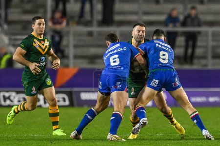 Photo for James Tedesco of Australia is tackled by Jack Campagnolo and Dean Parata of Italy during the Rugby League World Cup 2021 match Australia vs Italy at Totally Wicked Stadium, St Helens, United Kingdom, 29th October 202 - Royalty Free Image