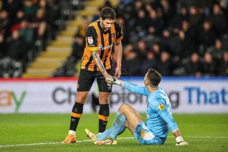 Photo for Tobias Figueiredo #6 of Hull City checks on an injured Nathan Baxter #13 of Hull City during the Sky Bet Championship match Hull City vs Middlesbrough at MKM Stadium, Hull, United Kingdom, 1st November 202 - Royalty Free Image