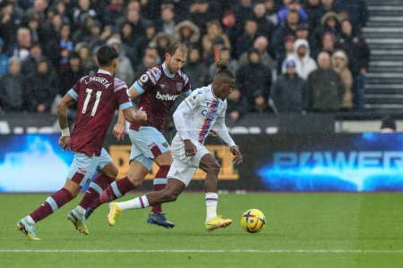 Photo for Wilfried Zaha #11 of Crystal Palace runs with the ball during the Premier League match West Ham United vs Crystal Palace at London Stadium, London, United Kingdom, 6th November 202 - Royalty Free Image