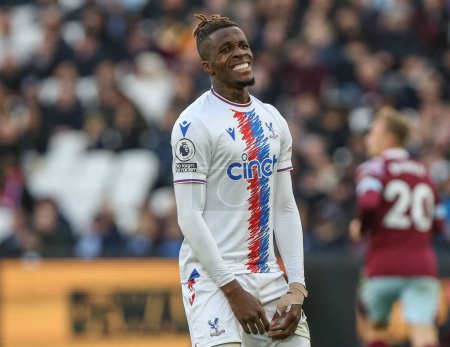 Photo for Wilfried Zaha #11 of Crystal Palace reacts to missing a chance to score during the Premier League match West Ham United vs Crystal Palace at London Stadium, London, United Kingdom, 6th November 202 - Royalty Free Image