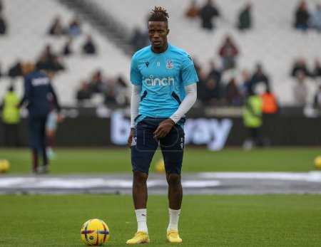 Photo for Wilfried Zaha #11 of Crystal Palace during the pre-game warm up ahead of the Premier League match West Ham United vs Crystal Palace at London Stadium, London, United Kingdom, 6th November 202 - Royalty Free Image