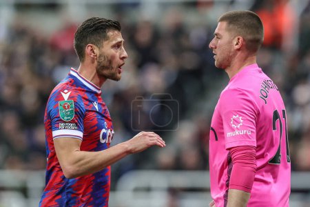 Photo for Joel Ward of Crystal Palace has words with Sam Johnstone #21 of Crystal Palace after hes caught of his line from a Jonjo Shelvey of Newcastle United 35 yard shot on goal during the Carabao Cup Third Round match Newcastle United vs Crystal Palace - Royalty Free Image