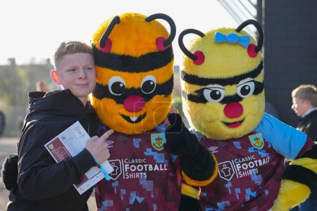 Photo for Burnley fan poses for a photo with Burnley mascots before the  before the Sky Bet Championship match Burnley vs Blackburn Rovers at Turf Moor, Burnley, United Kingdom, 13th November 202 - Royalty Free Image