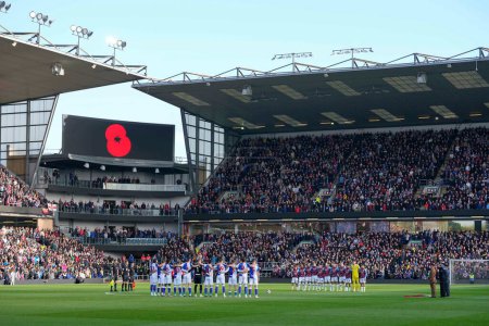 Photo for Players stand for a minutes silence for Remembrance Day during the Sky Bet Championship match Burnley vs Blackburn Rovers at Turf Moor, Burnley, United Kingdom, 13th November 202 - Royalty Free Image