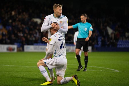 Photo for Elliott Nevitt #20 of Tranmere Rovers and Paul Lewis #22 of Tranmere Rovers react to receiving a penalty during the Sky Bet League 2 match Tranmere Rovers vs AFC Wimbledon at Prenton Park, Birkenhead, United Kingdom, 19th November 2022 - Royalty Free Image