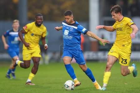 Photo for Alefe Santos #7 of Chippenham Town runs with the ball during the Emirates FA Cup Round 2 match Burton Albion vs Chippenham Town at Pirelli Stadium, Burton upon Trent, United Kingdom, 27th November 2022 - Royalty Free Image