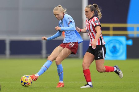Photo for Esme Morgan #14 of Manchester City passes the ball under pressure from Holly Manders #21 of Sunderland during the FA Womens Continental League Cup match Manchester City Women vs Sunderland AFC Women at Etihad Campus, Manchester, United Kingdom - Royalty Free Image