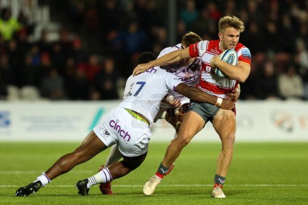 Photo for Chris Harris of Gloucester Rugby is tackled by Emmanuel Iyogun of Northampton Saints during the Gallagher Premiership match Gloucester Rugby vs Northampton Saints at Kingsholm Stadium , Gloucester, United Kingdom, 3rd December 202 - Royalty Free Image