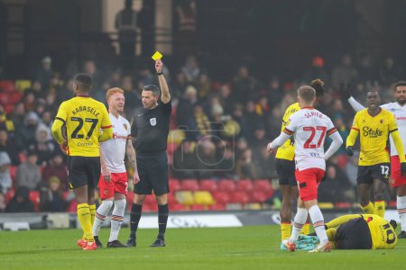 Photo for Ryan Woods #15 of Hull City receives a yellow card from referee Dean Whitestone during the Sky Bet Championship match Watford vs Hull City at Vicarage Road, Watford, United Kingdom, 11th December 2022 - Royalty Free Image