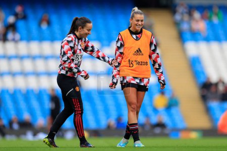 Photo for Alessia Russo #23 of Manchester United shares a laugh with Lucy Staniforth #37 of Manchester United during the warm up ahead of the The FA Women's Super League match Manchester City Women vs Manchester United Women at Etihad Campus, Manchester, UK - Royalty Free Image
