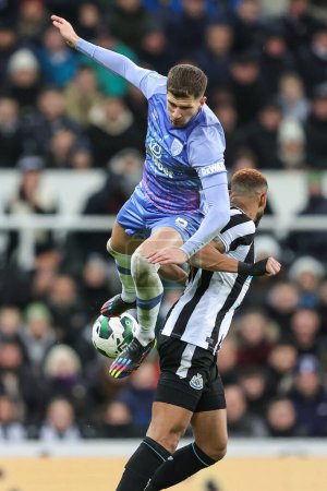 Photo for Chris Mepham #6 of Bournemouth and Joelinton #7 of Newcastle United battle for the ball during the Carabao Cup Fourth Round match Newcastle United vs Bournemouth at St. James's Park, Newcastle, United Kingdom, 20th December 202 - Royalty Free Image