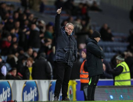 Photo for Steve Cooper manager of Nottingham Forest gives the fans the thumbs up as they chant his name during the Carabao Cup Fourth Round match Blackburn Rovers vs Nottingham Forest at Ewood Park, Blackburn, United Kingdom, 21st December 202 - Royalty Free Image