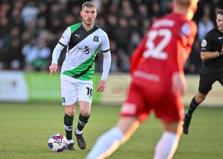 Photo for Plymouth Argyle midfielder Danny Mayor  (10) on the ball and looks for pass  during the Sky Bet League 1 match Cheltenham Town vs Plymouth Argyle at The Jonny-Rocks Stadium, Cheltenham, United Kingdom, 26th December 202 - Royalty Free Image