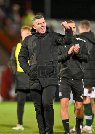 Photo for Plymouth Argyle Manager Steven Schumacher celebrates a win at full time  during the Sky Bet League 1 match Cheltenham Town vs Plymouth Argyle at The Jonny-Rocks Stadium, Cheltenham, United Kingdom, 26th December 202 - Royalty Free Image
