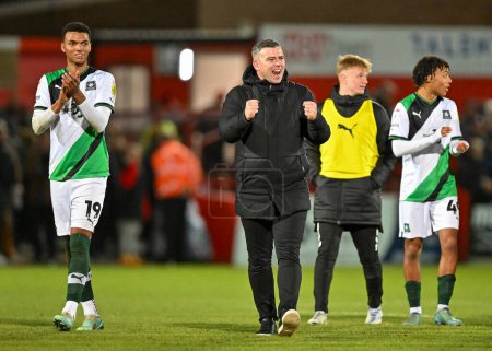 Photo for Plymouth Argyle Manager Steven Schumacher celebrates a win at full time  during the Sky Bet League 1 match Cheltenham Town vs Plymouth Argyle at The Jonny-Rocks Stadium, Cheltenham, United Kingdom, 26th December 202 - Royalty Free Image