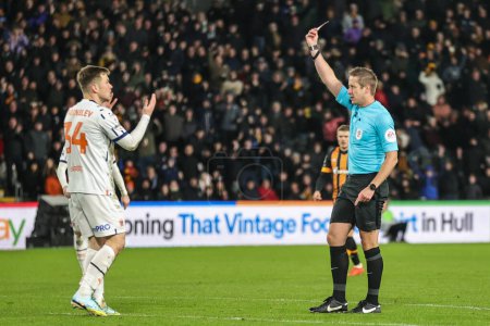 Photo for Jordan Thorniley #34 of Blackpool brings down the last man scar Estupin #19 of Hull City and is given a red card by referee John Brooks during the Sky Bet Championship match Hull City vs Blackpool at MKM Stadium, Hull, United Kingdom - Royalty Free Image