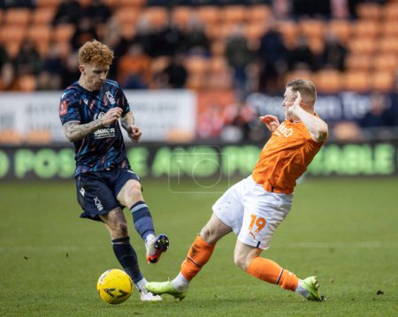 Photo for Jack Colback #8 of Nottingham Forest is tackled by Shayne Lavery #19 of Blackpool during the Emirates FA Cup Third Round match Blackpool vs Nottingham Forest at Bloomfield Road, Blackpool, United Kingdom, 7th January 202 - Royalty Free Image