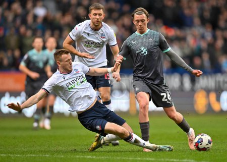 Foto de Bolton Wanderers defender Eoin Toal  (18) sliding tackle and wing the ball from Plymouth Argyle midfielder Callum Wright (26)   during the Sky Bet League 1 match Bolton Wanderers vs Plymouth Argyle at University of Bolton Stadium, Bolton, United King - Imagen libre de derechos