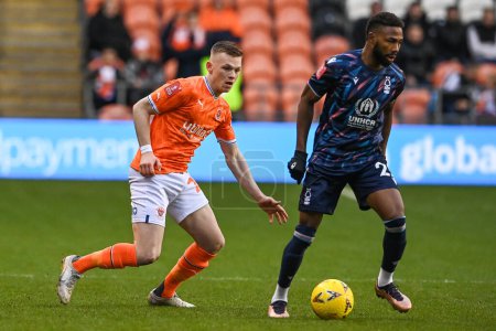 Photo for Andy Lyons #24 of Blackpool and Emmanuel Dennis #25 of Nottingham Forest battle for the ball during the Emirates FA Cup Third Round match Blackpool vs Nottingham Forest at Bloomfield Road, Blackpool, United Kingdom, 7th January 202 - Royalty Free Image