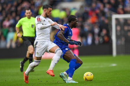 Photo for Sheyi Ojo #10 of Cardiff City  under pressure from Sam Greenwood #42 of Leeds United  during the Emirates FA Cup Third Round match Cardiff City vs Leeds United at Cardiff City Stadium, Cardiff, United Kingdom, 8th January 202 - Royalty Free Image