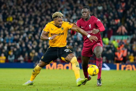 Téléchargez les photos : Ibrahima Konat #5 of Liverpool competes for the ball with Adama Traor #37 of Wolverhampton Wanderers during the Emirates FA Cup Third Round match Liverpool vs Wolverhampton Wanderers at Anfield, Liverpool, United Kingdom, 7th January 2023 - en image libre de droit