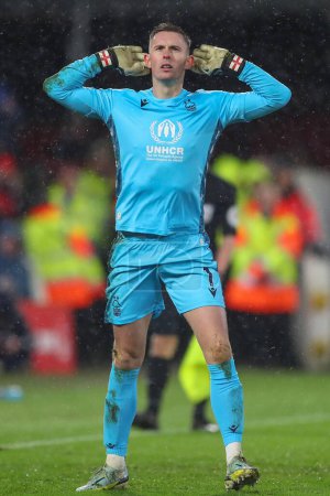 Photo for Dean Henderson #1 of Nottingham Forest celebrates saving a penalty from Rubn Neves #8 of Wolverhampton Wanderers during the Carabao Cup Quarter Final match Nottingham Forest vs Wolverhampton Wanderers at City Ground, Nottingham, United Kingdom - Royalty Free Image