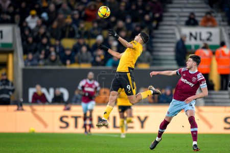 Photo for Raul Jimenez #9 of Wolverhampton Wanderers wins a header in front of Declan Rice #41 of West Ham United during the Premier League match Wolverhampton Wanderers vs West Ham United at Molineux, Wolverhampton, United Kingdom, 14th January 202 - Royalty Free Image