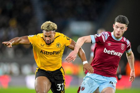 Photo for Adama Traore #37 of Wolverhampton Wanderers battles with Declan Rice #41 of West Ham United during the Premier League match Wolverhampton Wanderers vs West Ham United at Molineux, Wolverhampton, United Kingdom, 14th January 202 - Royalty Free Image