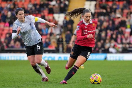 Photo for Vilde Boe Risa #8 of Manchester United breaks past Niamh Fahey #5 of Liverpool Women during the The Fa Women's Super League match Manchester United Women vs Liverpool Women at Leigh Sports Village, Leigh, United Kingdom, 15th January 202 - Royalty Free Image