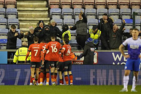 Foto de Luton Town players celebrate their winning goal in front of the travelling Hatters fans during the Emirates FA Cup match Third Round Replay Wigan Athletic vs Luton Town at DW Stadium, Wigan, United Kingdom, 17th January 202 - Imagen libre de derechos