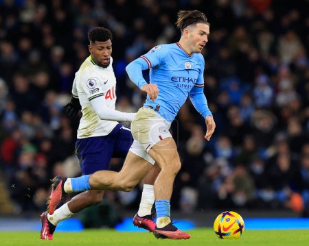 Photo for Jack Grealish #10 of Manchester City goes past Emerson Royal #12 of Tottenham Hotspur during the Premier League match Manchester City vs Tottenham Hotspur at Etihad Stadium, Manchester, United Kingdom, 19th January 202 - Royalty Free Image
